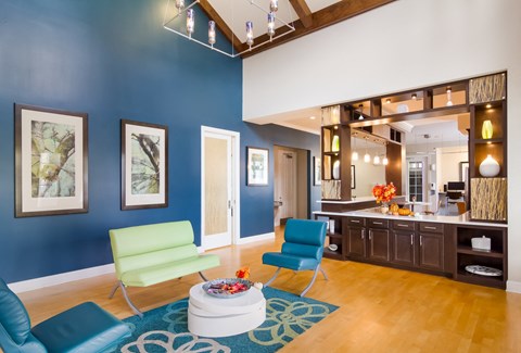 a living room with blue chairs and a coffee table